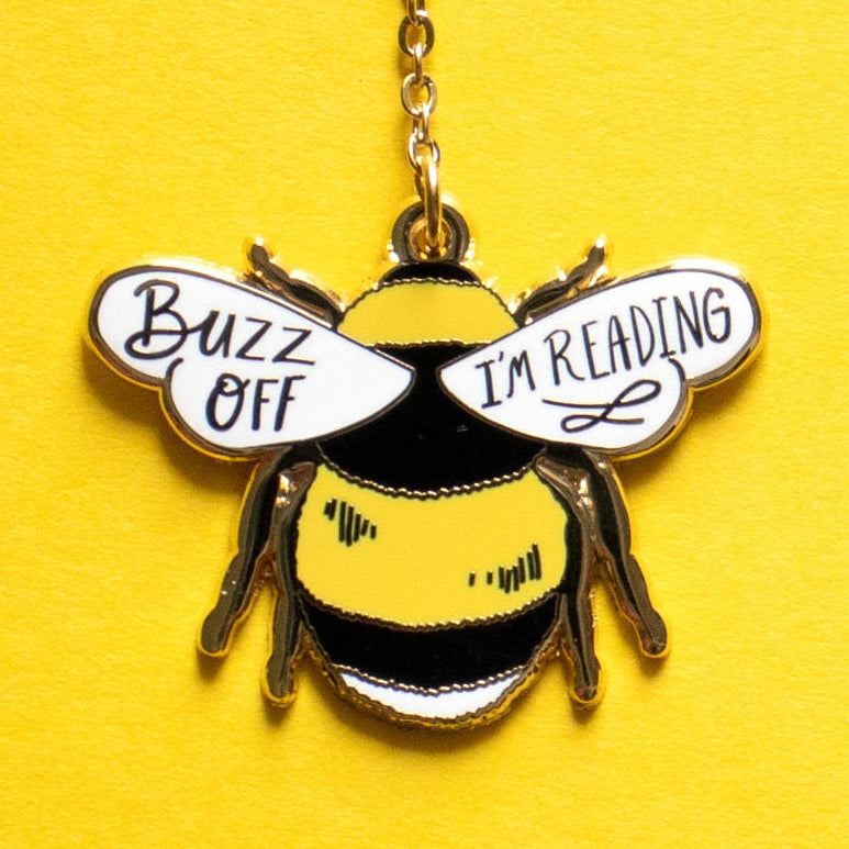 Bee-shaped pendant necklace with text on a yellow background