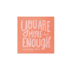Motivational quote 'You are more than enough and always will be' on a peach background