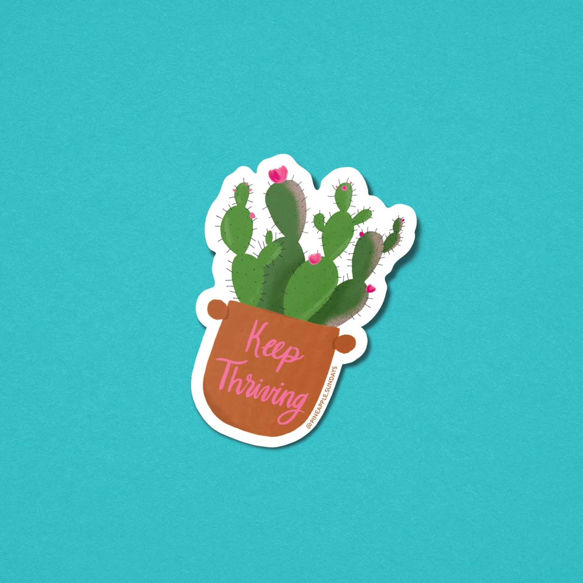 Sticker with a cactus plant and 'Keep Thriving' text on a teal background