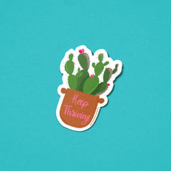 Sticker with a cactus plant and 'Keep Thriving' text on a teal background